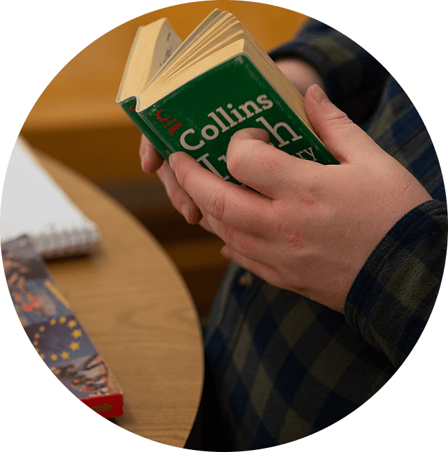 Pair of hands holding a Collins Irish Dictionary